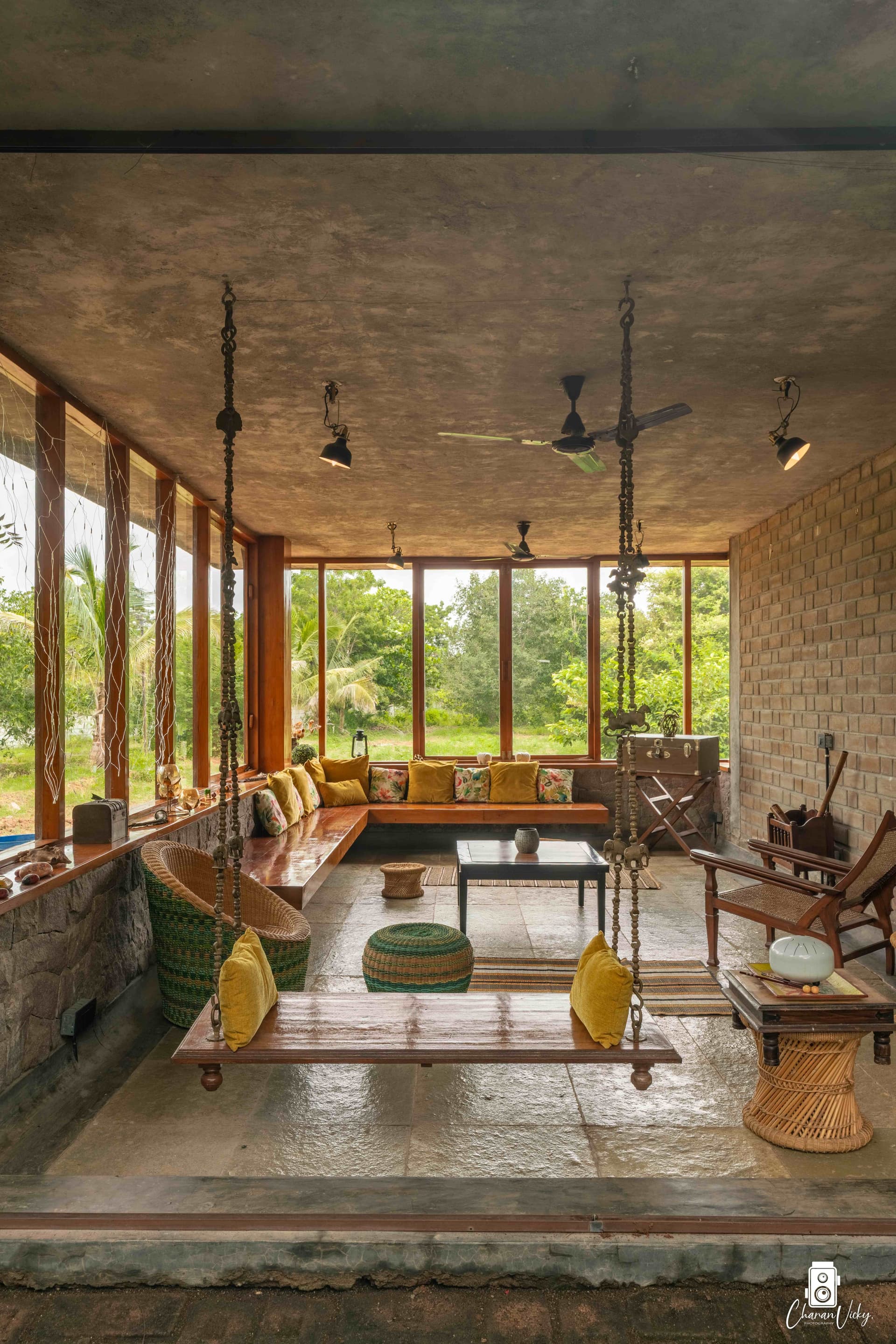 The swing room — teak, brick, and forest light