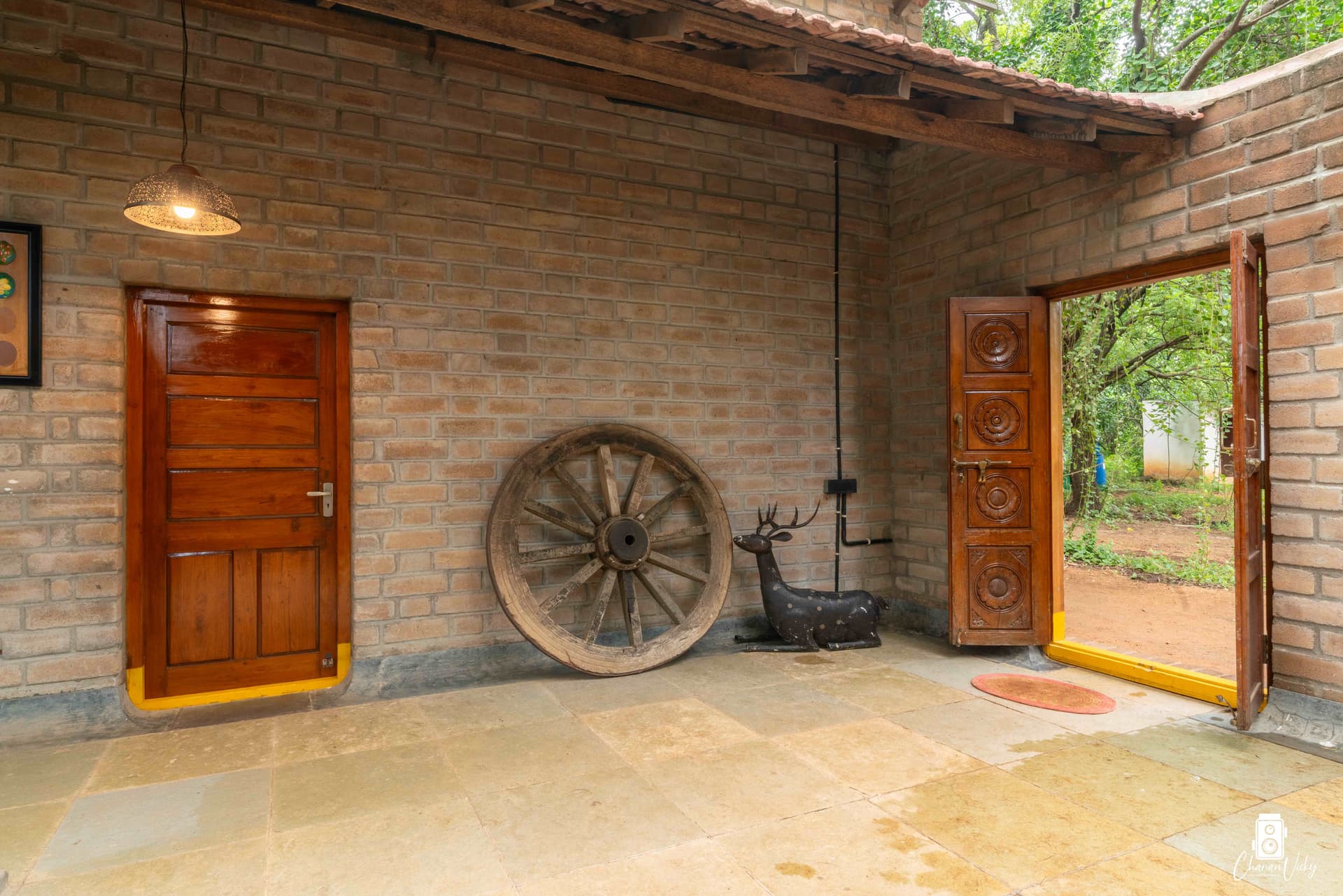 Vintage cart wheel and carved teak door